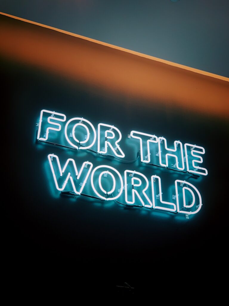 A neon sign says "For the world"